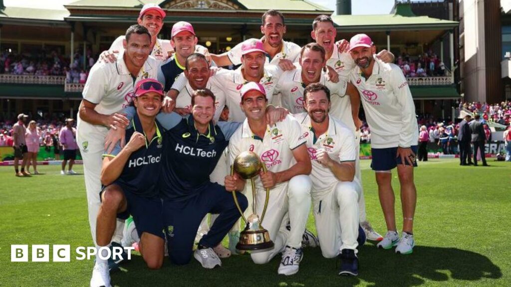 Australia team celebrate beating India with captain Pat Cummins holding the Border-Gavaskar trophy