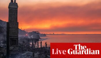 California fires live: progress made against some LA blazes but thickening smoke prompts ‘health emergency’