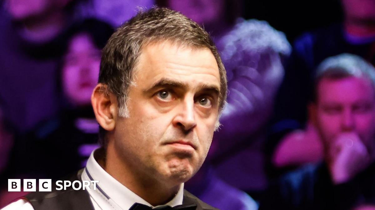 Ronnie O'Sullivan looks at a snooker table