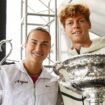 Aryna Sabalenka and Jannik Sinner pose with the Australian Open trophies at Melbourne Park