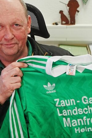 Der Heinsberger Firmenchef Manfred Fell und das berühmte Trikot. Foto: Thomas Frey/dpa