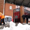 Workers clear snow outside Liverpool's Anfield Stadium