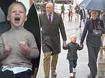 Lucas Tindall, 3, delights with his cheeky antics as he joins parents Mike and Zara at New Year's Day meeting at Cheltenham Racecourse