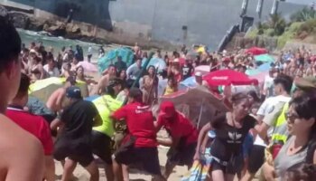 Moment 20-strong group brawl breaks out on Chile beach with one man stabbed and 4 arrested