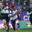 man running with rugby ball wearing green/yellow and black strip. two men in his wake, one shouting, wearing green/yellow and black strip and the other in white and blue - crowd out of focus in background