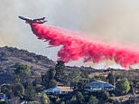 Painting LA pink! Fire retardant stains houses that still stand and everything around them in an attempt to slow the blazes that have killed at least 16 people