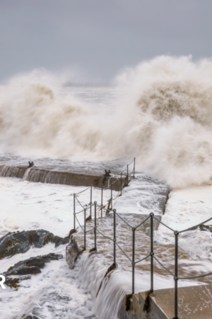 Large waves overtopping steps and rocks on the coast