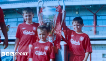 Accrington Stanley forward Josh Woods (front) aged five in his Liverpool kit with the 2005 Champions League trophy with his brothers Connor (right) and Dale (left)