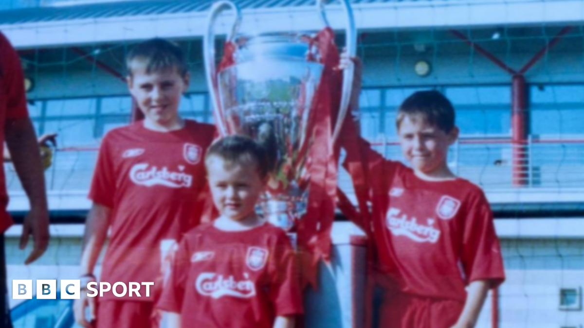 Accrington Stanley forward Josh Woods (front) aged five in his Liverpool kit with the 2005 Champions League trophy with his brothers Connor (right) and Dale (left)