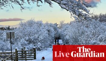 UK weather warnings in place as country hit by snow and freezing rain – live updates