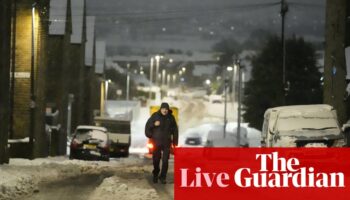 UK weather: ‘extensive flooding’ closes M5 in Gloucestershire as heavy snow and ice causes travel chaos across country – live