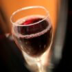 A glass of Beaujolais Nouveau wine is pictured in a restaurant of Boulogne Billancourt, outside Paris, Thursday, Nov. 18, 2021. Each year, on the third Thursday in November at the stroke of midnight, the world welcomes in the new Beaujolais Nouveau vintage, a light red wine, produced in the Beaujolais region of southern Burgundy. (AP Photo/Christophe Ena)