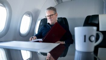 Prime Minister Sir Keir Starmer working on a government plane on his way to the G20 summit in Rio in November 2024. Pic: Reuters