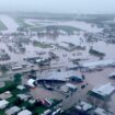 Woman dies and thousands urged to move to higher ground as 'record-breaking rainfall' hits Queensland