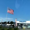 Camping World CEO defies another city's threat of legal action over huge American flag: Not 'coming down'