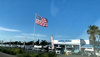 Camping World CEO defies another city's threat of legal action over huge American flag: Not 'coming down'