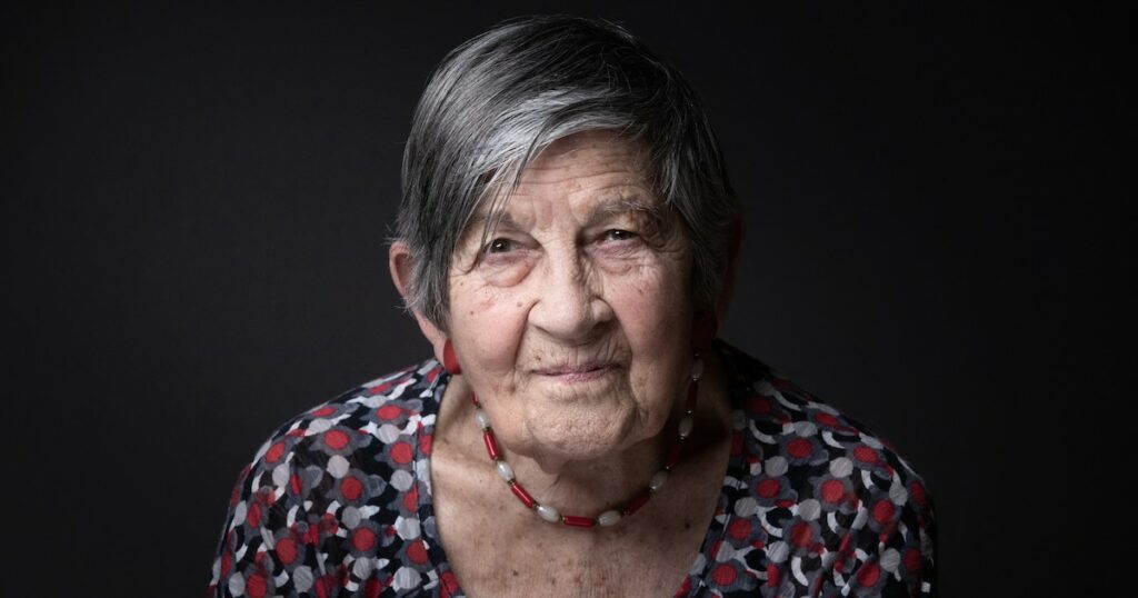 Holocaust Survivor of the concentration and extermination camp of Auschwitz-Birkenau Ginette Kolinka poses during a photo session, in Paris, on April 15, 2022. (Photo by JOEL SAGET / AFP)