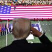 President Trump salutes during the national anthem at the Super Bowl. Pic: Reuters