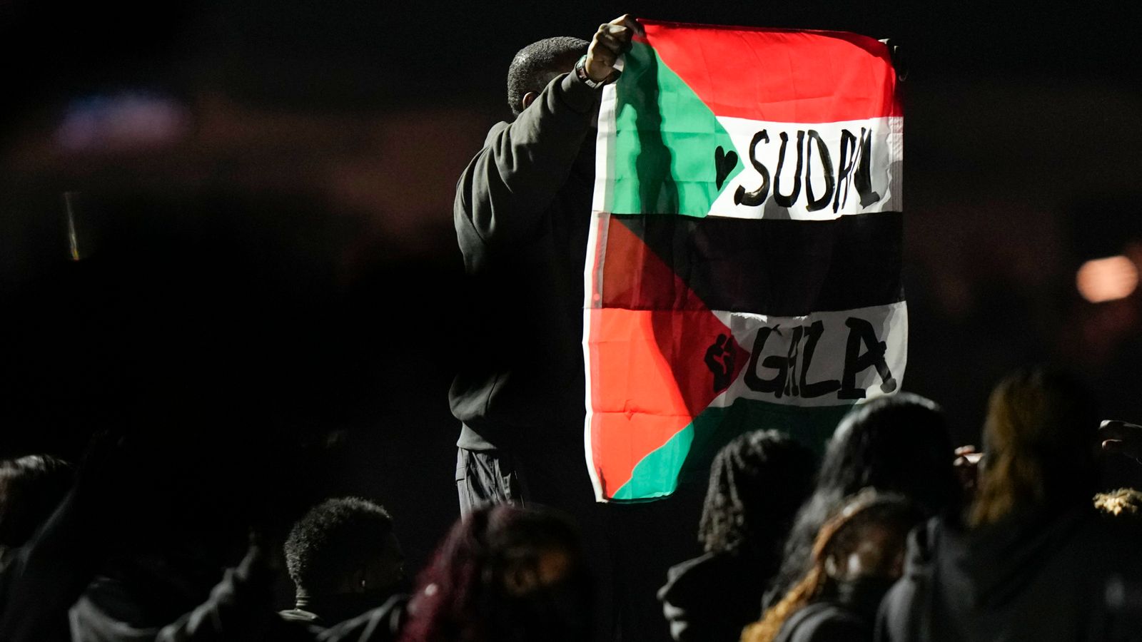 The protester unfurled Palestinian and Sudanese flags. Pic: AP