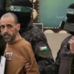 Israeli captive Eli Sharabi, is escorted by Hamas fighters before being handed over to the Red Cross. Pic: AP