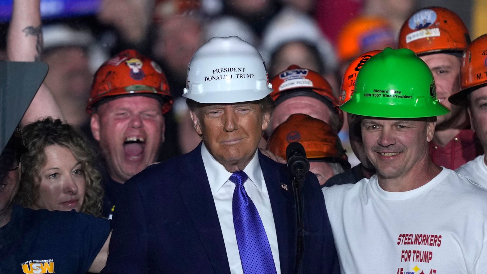 Donald Trump stands on stage with steelworkers as he speaks at a campaign rally in Pennsylvania. Pic: AP