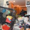 Cages balanced on piles of rubbish in a Long Island home where 10 dead animals were found. Pic: Suffolk County SPCA