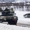 Finnish soldiers of the Finnish-Swedish Division ride the Leopard 2A6, a third generation German main battle tank, during a demonstration of border crossing by Swedish and Finnish troops as part of the NATO Nordic Response 24 military exercise on March 9, 2024 on the Norwegian side of the Kivilompolo border crossing between Finland and Norway, located above the Arctic Circle. Nordic Response 24 is part of the larger NATO exercise Steadfast Defender. The exercise involves air, sea, and land forces, with over 100 fighter jets, 50 ships, and over 20,000 troops practicing defensive manoeuvres in cold and harsh weather conditions. (Photo by Jonathan NACKSTRAND / AFP)