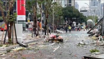 This image taken from video by Taiwan's TVBS shows the debris are strewn across the streets in the aftermath of an explosion at the Shin Kong Mitsukoshi department store in Taichung city in Taiwan on Thursday, Feb. 13, 2025. (TVBS via AP )