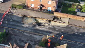 Massive 60ft hole opens in middle of UK high street as buildings evacuate