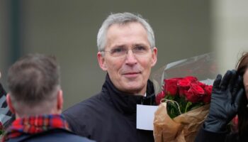 Jens Stoltenberg mit einem Bouquet roter Rosen