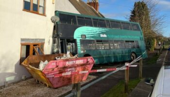 School bus horror as double decker crashes into side of house in UK village