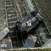 Travel chaos after car plummets on to railway line