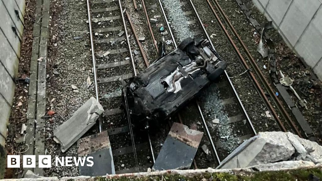 Travel chaos after car plummets on to railway line