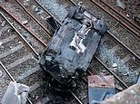 Travel chaos between two major cities after car plunges onto railway tracks - as driver is arrested